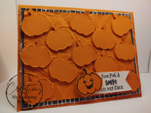 Halloween card featuring twelve punched pumpkins, one smiling at the viewer with the caption 'You put a smile on my face'