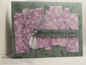 Light green card base decorated with stamped leaves and strips of light purple paper with white leaves, with the sentiment Thinking of You
