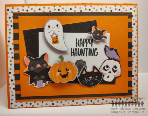 Halloween card with layers of patterned Halloween paper in orange, black, green and purple, with the sentiment 'Happy Haunting' and small images of a bat, jack'o'lantern, cat, skull, and ghost
