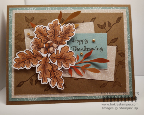 Thanksgiving card with layers of pattern paper in shades of brown and green with the sentiment 'Happy Thanksgiving' and images of brown and gold leaves