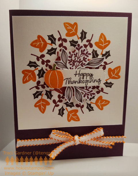 Thanksgiving wreath card featuring a round wreath created with stamped leaves in orange, dark red, and green
