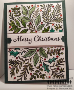 Christmas Card showing an arrangement of green leaves and red berries.
