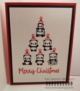 Christmas card showing seven pandas stacked up to form a Christmas tree. There is a Santa hat on the top of each. At the very top of the tree, a baby panda sits on top of its mama.