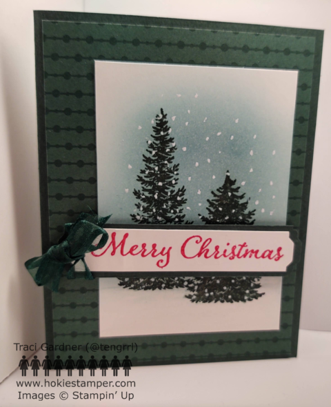 Christmas card on dark green paper showing two pine trees on a snowy landscape, with the sentiment Merry Christmas