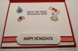Inside of the Poodle Christmas Card, which shows the sentiment Deck the Halls with bows and wows, along with images of an ornament with a paw print, bones with red ribbons, and a paw shaped stocking