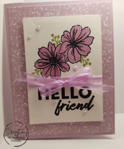 Light purple card showing two purple flowers with a purple ribbon and the sentiment, Hello Friend