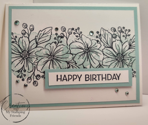 White card with a stripe of blue flowers across the center and the sentiment, Happy Birthday