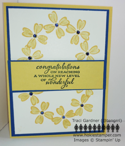 Yellow, blue, and white card featuring an oval wreath of yellow flowers and the sentiment, Congratulations on reaching a whole new level of wonderful