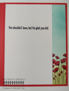 Inside of red card with a strip of paper showing a blue sky and field of poppies, matching the card front, and the sentiment, You shouldn't have, but I'm glad you did.