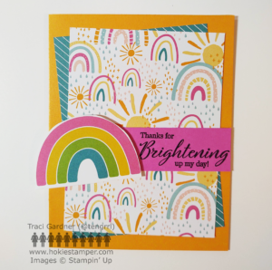 A cheerful card on golden orange cardstock with paper showing rainbows and sun, with the sentiment, Thanks for brightening up my day!