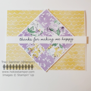 A card focusing on a 3 x 3 quilt-square pattern, with flowers and leaves in pastel shades of purple, yellow, and green with the sentiment, thanks for making me happy