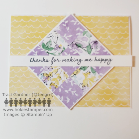A card focusing on a 3 x 3 quilt-square pattern, with flowers and leaves in pastel shades of purple, yellow, and green with the sentiment, thanks for making me happy