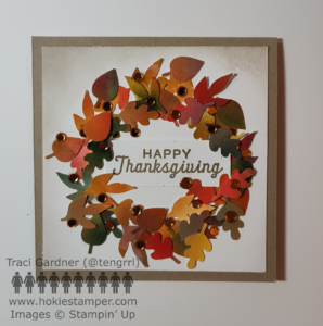 Greeting card showing a circular wreath of small fall leaves (yellow, orange, red, green, and brown), with the sentiment Happy Thanksgiving