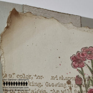 Close-up of card showing curled and inked torn edges of the card front