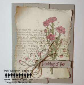 Vintage look greeting card with overlapping worn typed text, red flowers, and ink splatters, with the sentiment Thinking of You