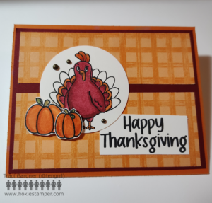 Maroon and orange Thanksgiving card with two rectangles of orange gingham in the background. A maroon and orange HokieBird (okay, a Turkey) stands as the focal point with two pumpkins at his feet. The sentiment reads Happy Thanksgiving.