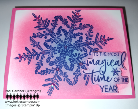 Greeting card with ink blended shades of pink, purple, and blue in the background and a giant darker blue snowflake stamped on top, with the sentiment It's the most magical time of the year.