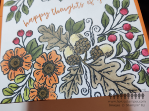 Detail showing glittery effect on flowers, acorns, and berries in the large sprays of fall foliage, with part of the sentiment Happy Thoughts of You across the middle. 