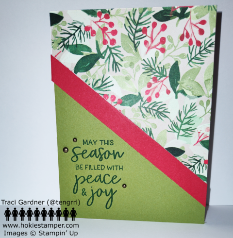 December holiday card with a patterned piece of paper in the upper right, showing green and red foliage. The card has a piece of green paper and a red diagonal strip of paper on the lower left. The sentiment is May this season be filled with peace and joy.