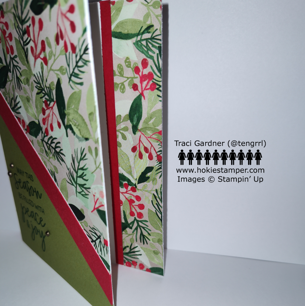 Image showing the front of the card on the left, revealing the inside on the right, which includes a strip of the foliage paper and a red stripe.