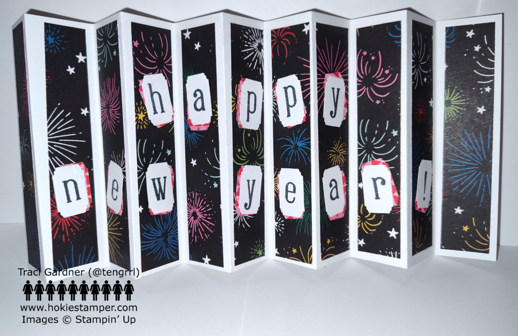 An accordion card with a white background and black patterned paper, showing colorful fireworks, and the message Happy New Year!