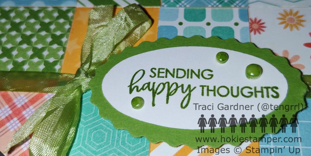 Close-up on the greeting card's sentiment, Sending Happy Thoughts, showing the ribbon and embellishments colored with an alcohol marker